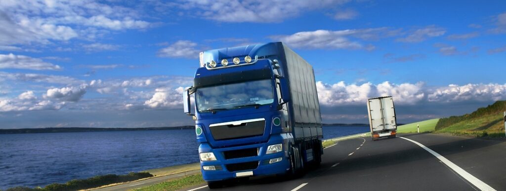 Blue freight truck moving on the road