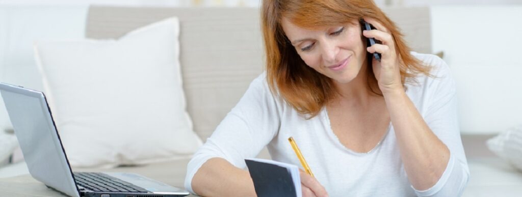 A woman on the phone scheduling an appointment