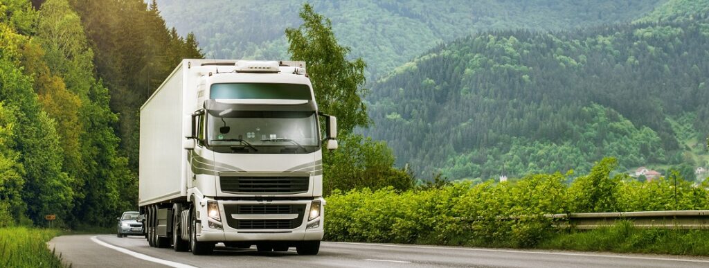 A freight truck moving through a mountain range