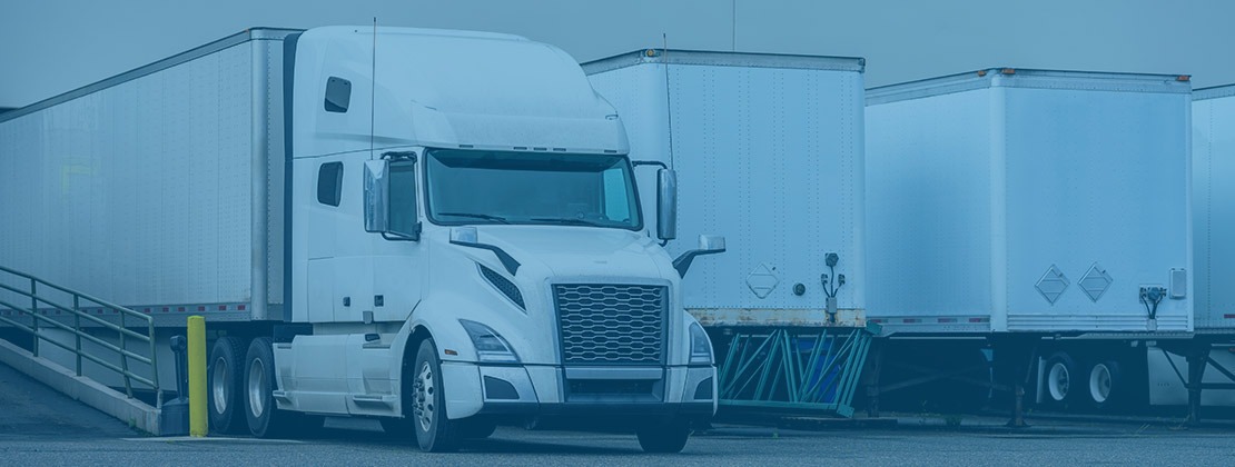 A freight truck parked at a loading dock