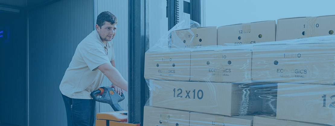 Man moving properly packaged freight on a pallet via pallet jack