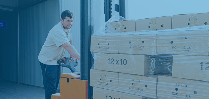 Man moving properly packaged freight on a pallet via pallet jack