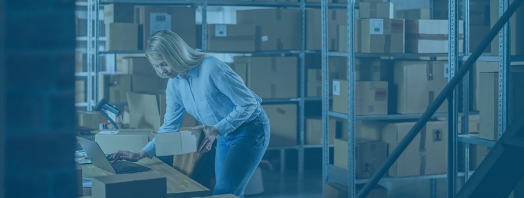 Dock worker inspecting shipment paperwork