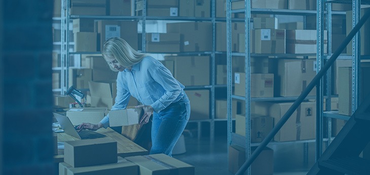 Dock worker inspecting shipment paperwork