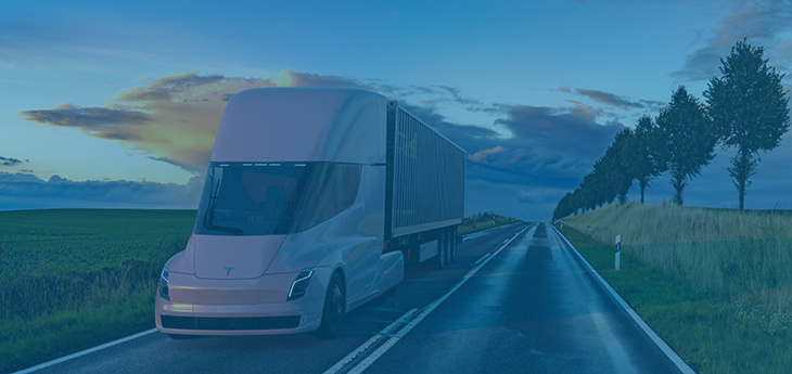 An electric truck hauling freight by road