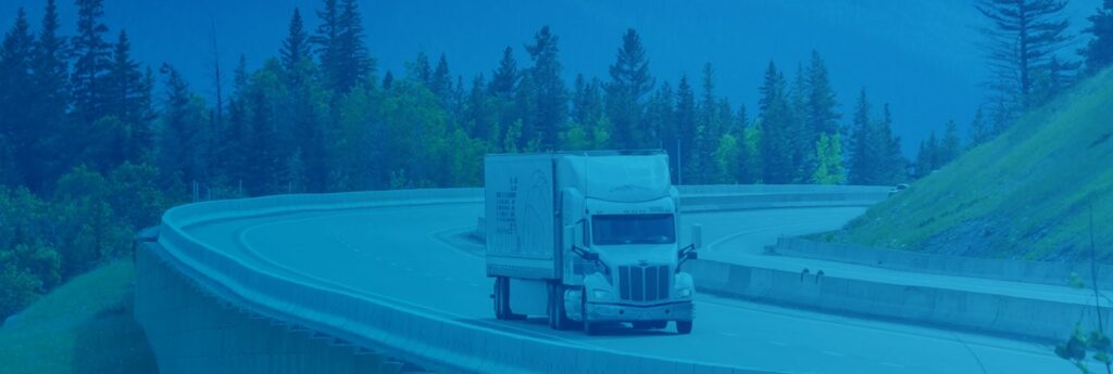 A freight truck traveling by road