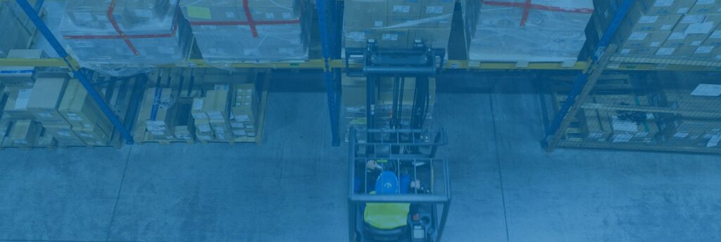 A forklift moving cargo within a warehouse